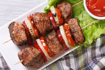 shashlik with vegetables and sauce top view