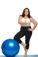 Fototapeta na wymiar Happy woman with excess weight and ball