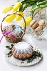 Easter cake and bouquet of yellow tulips on the table