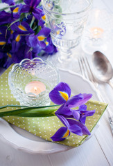 table setting with purple iris flowers