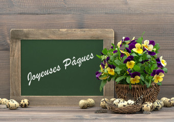 easter decoration pansy flowers and blackboard