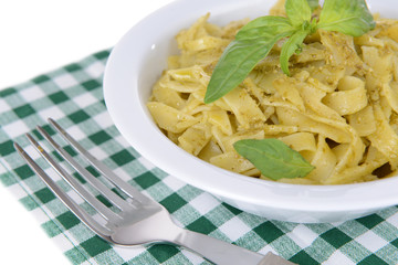 Delicious pasta with pesto on plate on table close-up