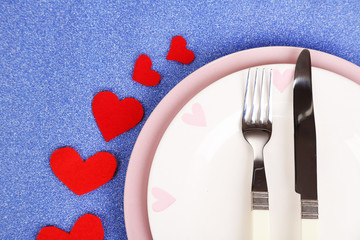 Valentines day dinner with table setting on blue background
