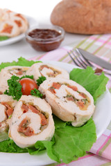 Delicious chicken roll on plate on table close-up
