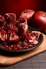 Ripe pomegranates on table close-up