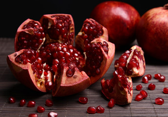 Ripe pomegranates on table close-up
