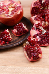 Ripe pomegranates on table close-up
