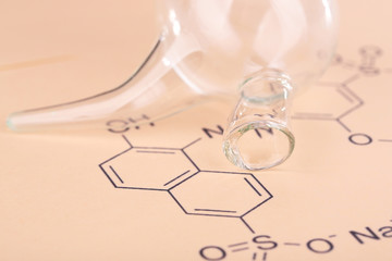Test tube and reaction formula, close-up