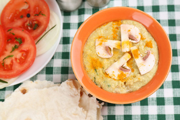 Bowl of tasty fresh hummus with tomatoes