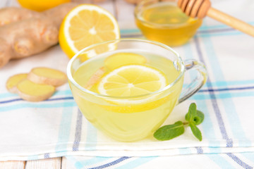 Healthy ginger tea with lemon and honey on table close-up
