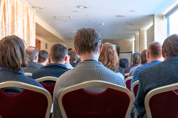 people sitting rear at the business conference