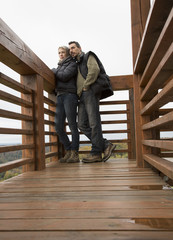 Woman and man on wooden viewpoint