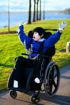Disabled boy in wheelchair enjoying day at park