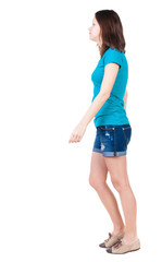 back view of walking  woman in shorts.