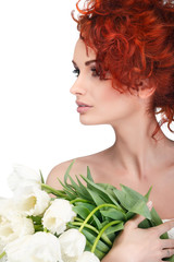 Obraz na płótnie Canvas beautiful young redheaded girl with white tulips