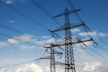 Electricity pylon against blue sky