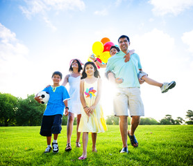 Family In Outdoors Walking Towards Camera