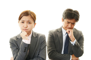 苦悩するビジネスマンとOL