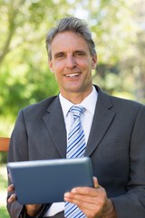 Portrait of businessman using digital tablet