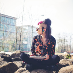 young beautiful punk dark girl using tablet