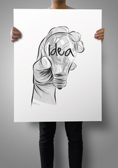 man showing poster of Hand drawn light bulb with IDEA word on cr
