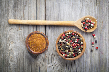 Colored Pepper in the wooden bowl, on wooden board