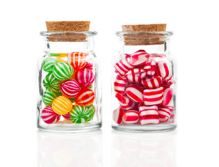 two filled glass candy jars isolated over white background