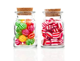Tuinposter two filled glass candy jars isolated over white background © motorolka