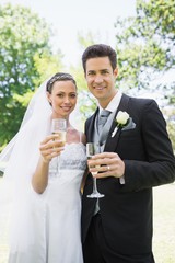 Bride and groom toasting champagne