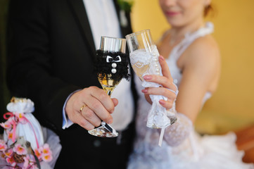 bride and groom holding beautiful wedding champagne glasses