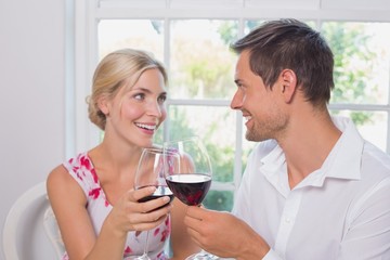 Loving couple with wine glasses looking at each other