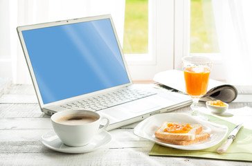 Continental breakfast and laptop computer