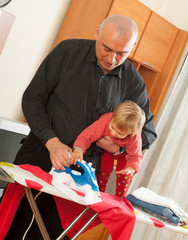 dad with baby in  arms for ironing