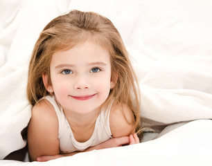 Adorable smiling little girl waked up