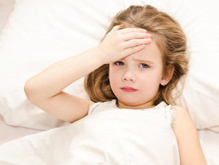 Fototapeta premium Sick little girl lying in the bed