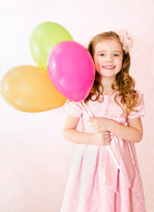 Fototapeta na wymiar Cute smiling little girl with balloons