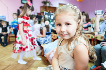 Pretty young girl sitting in kindergarten lesson