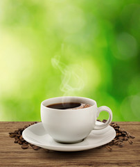 Coffee cup and saucer on a wooden table (clipping path).