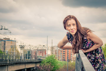 Pretty girl posing on railroad bridge