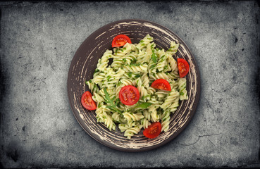 Fusilli pasta with tomato and arugula