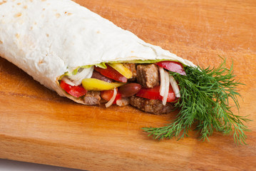 beef burrito with peppers, onion and tomato