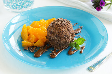 Chocolate ice cream in chocolate chips and oranges.