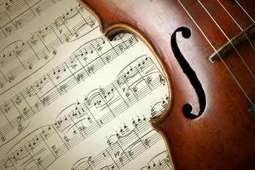 Detail of old scratched violin on music sheet