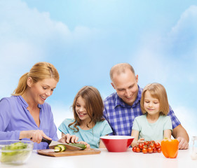 happy family with two kids making dinner at home