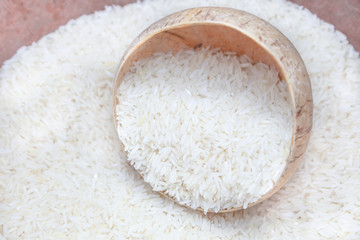 Uncooked rice in coconut shell bowl