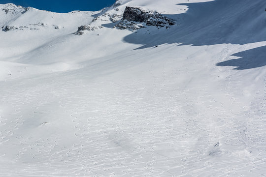 Mountain slope with ski tracks