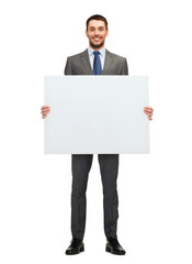 smiling businessman with white blank board