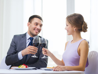 couple with main course and red wine at restaurant