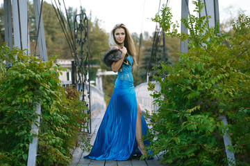 Fototapeta premium Beautiful blondy young woman wearing elegant blue dress