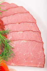 Sliced meat on the plate close up